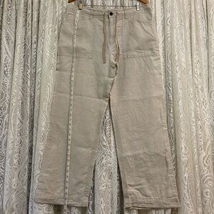 100 percent linen trousers. Button and zippered closure with tie at waist.